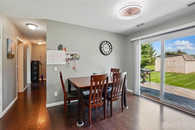 dining space with baseboards, wood finished floors, and visible vents
