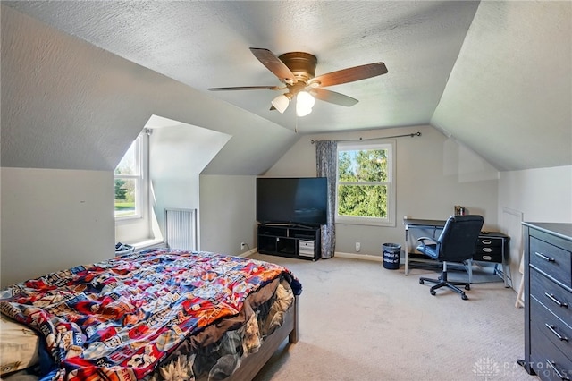 carpeted bedroom featuring vaulted ceiling, a textured ceiling, baseboards, and ceiling fan