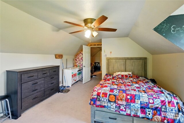 bedroom with vaulted ceiling, ceiling fan, and light carpet