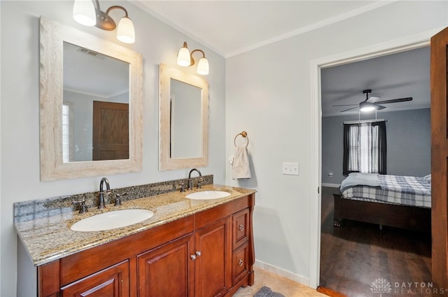 bathroom with visible vents, a sink, and ornamental molding