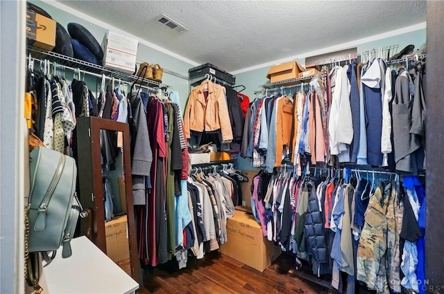 walk in closet with wood finished floors and visible vents