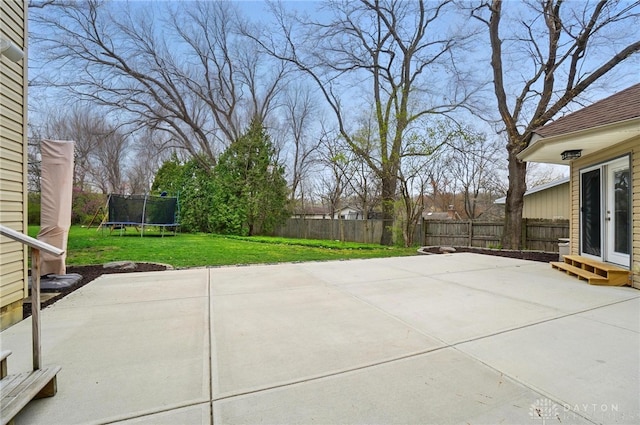 view of patio with a fenced backyard and a trampoline