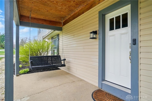 view of exterior entry with a porch
