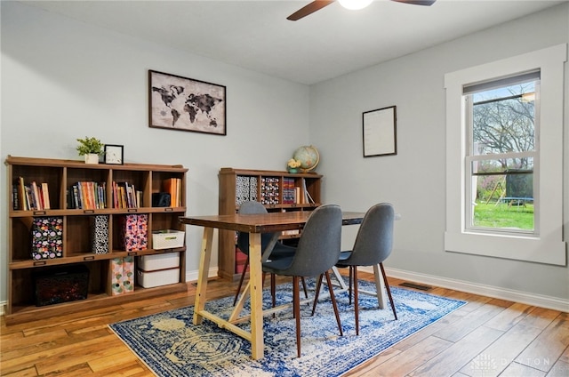 office featuring wood finished floors, visible vents, a ceiling fan, and baseboards