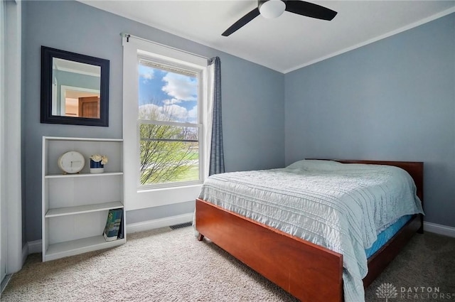 carpeted bedroom featuring baseboards and a ceiling fan