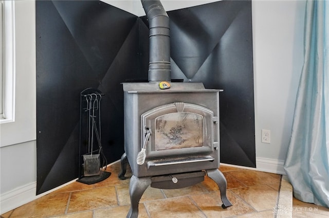 room details with a wood stove and baseboards