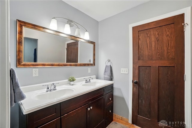 full bathroom featuring a sink and double vanity