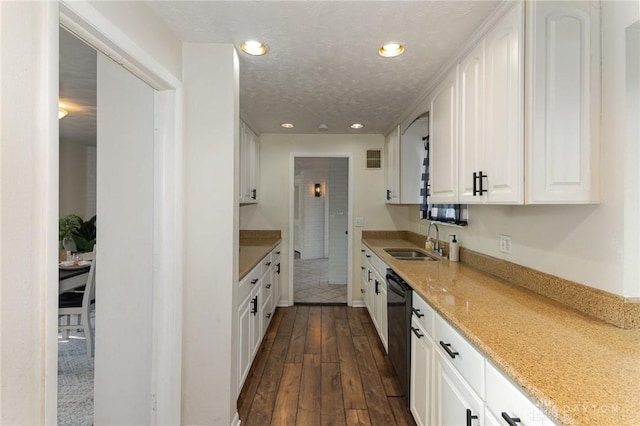 330 Rumson St, Englewood, OH 45322 - kitchen featuring white cabinets, dark wood finished floors, light stone counters, a sink, and black dishwasher