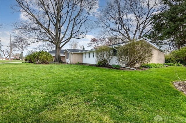 330 Rumson St, Englewood, OH 45322 - view of side of property featuring brick siding and a lawn