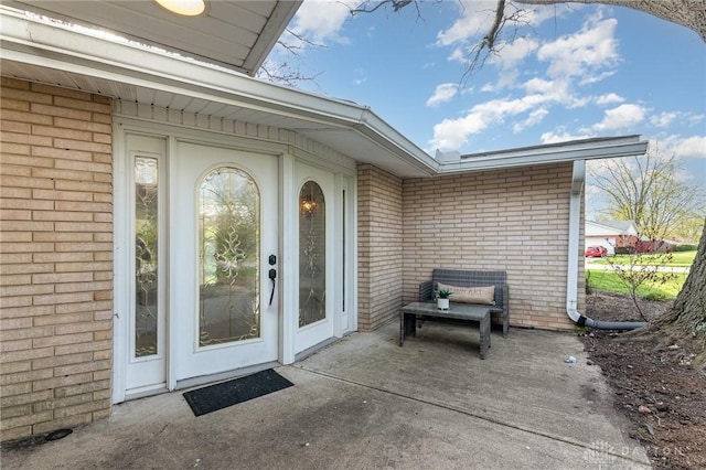 330 Rumson St, Englewood, OH 45322 - view of exterior entry featuring brick siding and a patio
