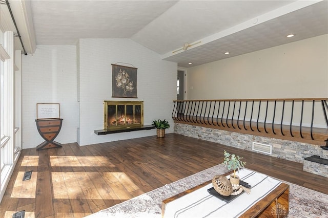 330 Rumson St, Englewood, OH 45322 - unfurnished living room with lofted ceiling, a glass covered fireplace, hardwood / wood-style flooring, and visible vents