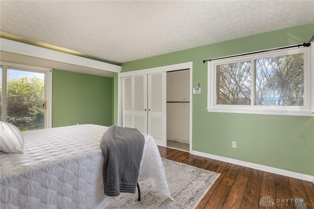 330 Rumson St, Englewood, OH 45322 - bedroom featuring baseboards, a textured ceiling, a closet, and wood-type flooring