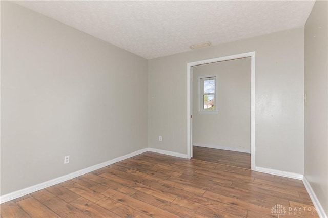 330 Rumson St, Englewood, OH 45322 - unfurnished room featuring hardwood / wood-style floors, baseboards, and a textured ceiling