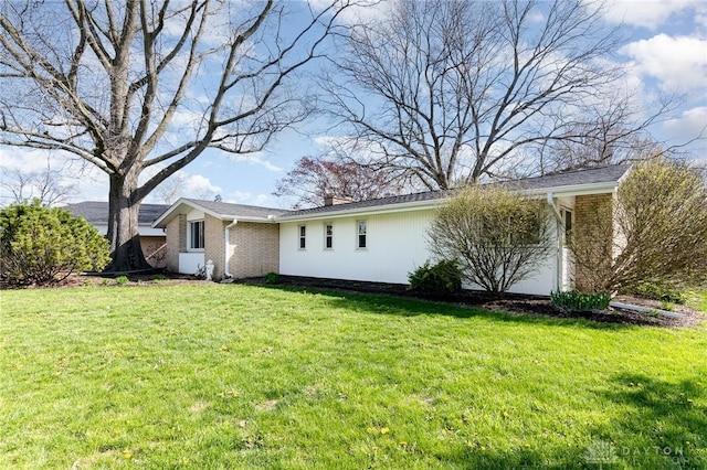 330 Rumson St, Englewood, OH 45322 - view of side of home featuring a chimney, brick siding, and a yard