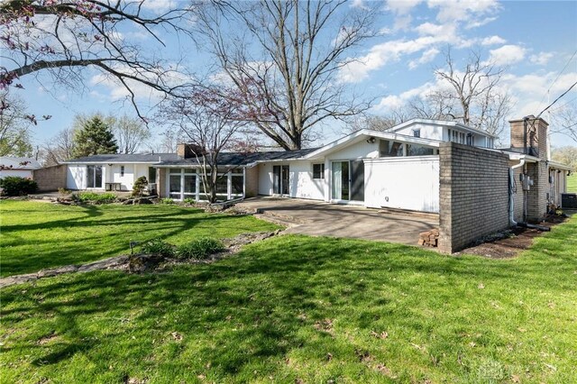 330 Rumson St, Englewood, OH 45322 - back of house featuring a yard, a patio area, central AC, and a chimney