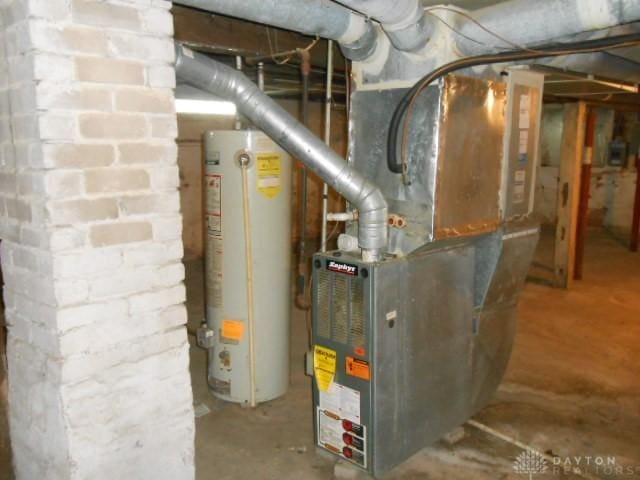 utility room with heating unit and water heater