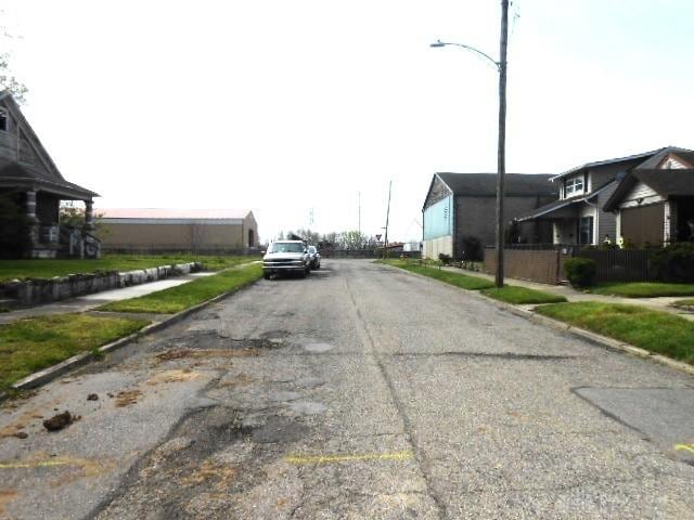 view of street with sidewalks, curbs, and street lighting