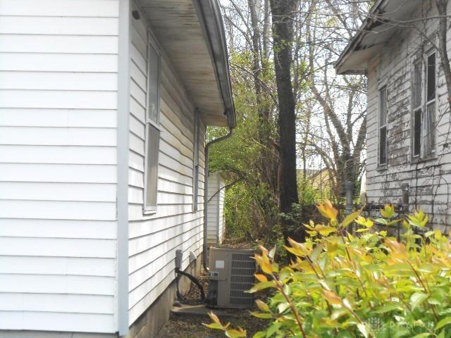 view of side of home with central AC unit