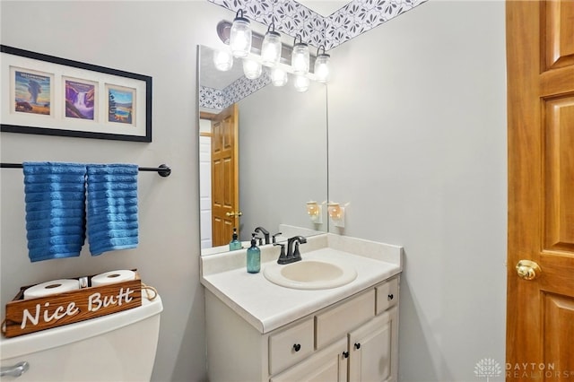 half bathroom featuring toilet and vanity