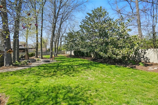 view of yard featuring a gazebo and a fenced backyard