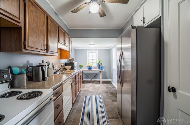kitchen with a sink, baseboards, a ceiling fan, white appliances, and ornamental molding