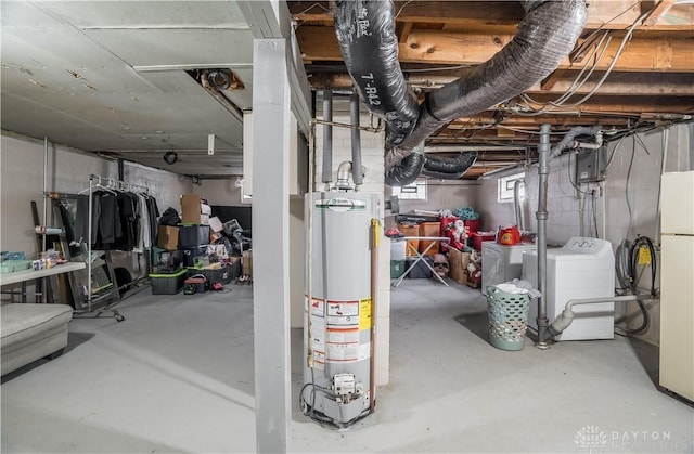 below grade area featuring water heater and freestanding refrigerator