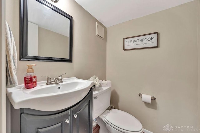 bathroom featuring toilet and vanity