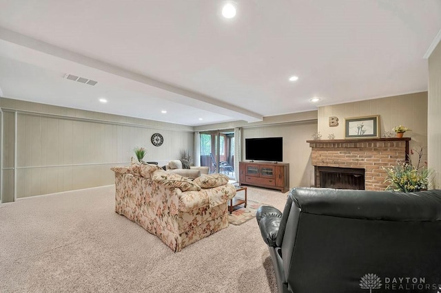 carpeted living room featuring recessed lighting, a decorative wall, visible vents, and a fireplace