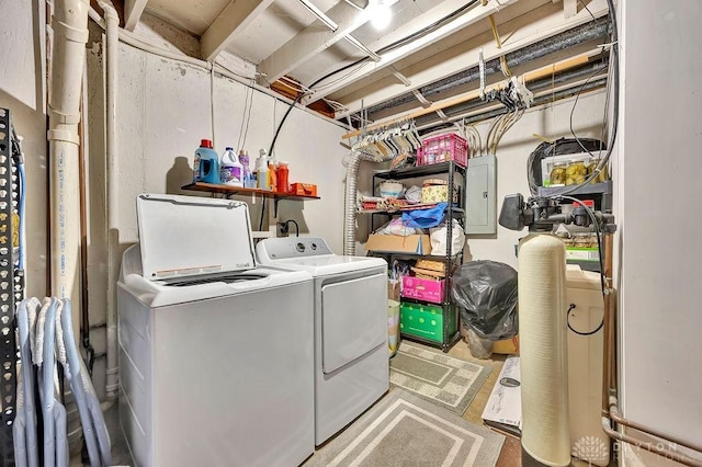 washroom featuring washer and clothes dryer, laundry area, and electric panel