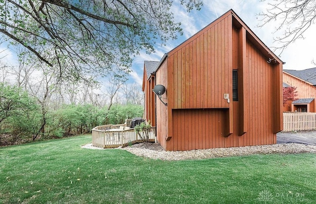exterior space featuring a lawn and an outdoor structure