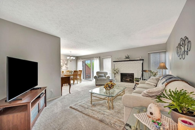 living room with a fireplace, carpet floors, a textured ceiling, and a notable chandelier