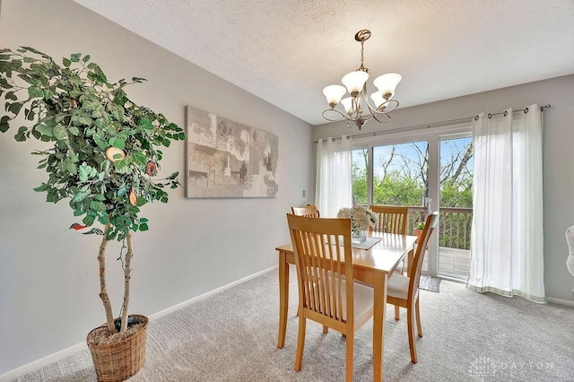 dining area featuring a textured ceiling, baseboards, light carpet, and an inviting chandelier