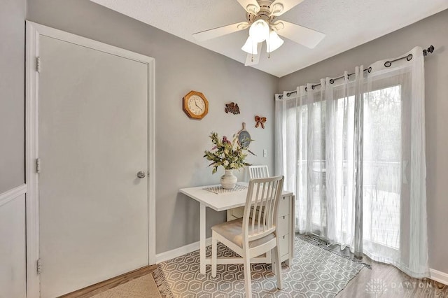 dining space featuring ceiling fan, baseboards, and a healthy amount of sunlight