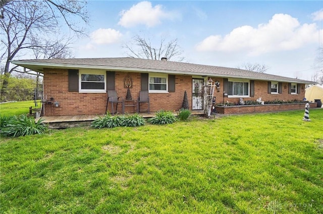 ranch-style house featuring brick siding and a front yard