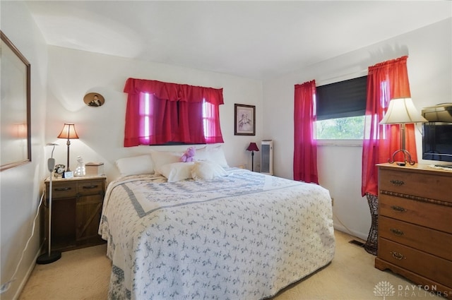 bedroom featuring light colored carpet