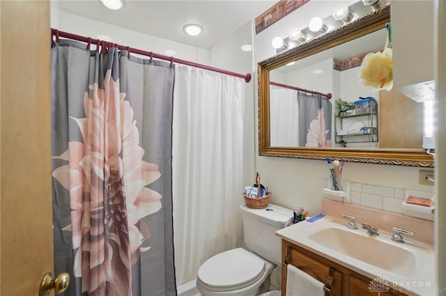 bathroom featuring vanity, curtained shower, and toilet