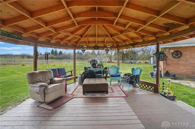 wooden terrace with a lawn, an outdoor hangout area, and a gazebo