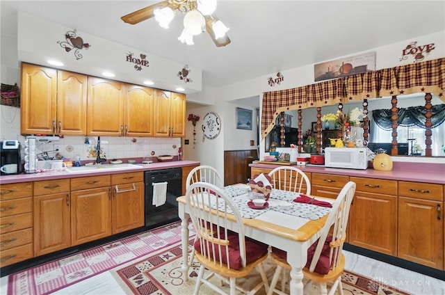 kitchen featuring dishwasher, a sink, white microwave, tasteful backsplash, and ceiling fan