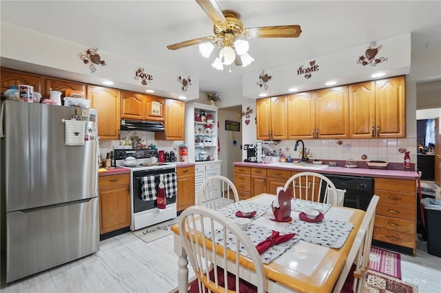 kitchen with under cabinet range hood, freestanding refrigerator, white range with electric cooktop, decorative backsplash, and ceiling fan