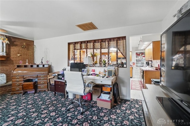 office featuring carpet floors, a healthy amount of sunlight, a sink, and visible vents