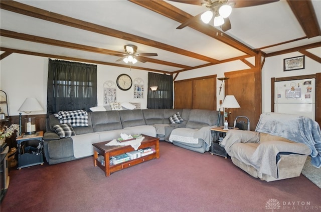 living area with beamed ceiling, a ceiling fan, and carpet floors