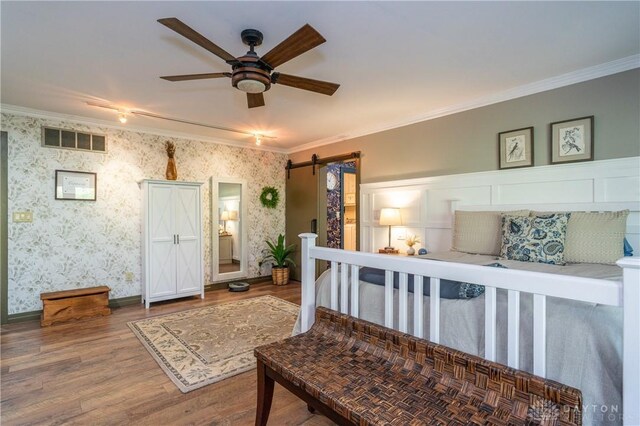 6475 Landsend Ct, Butler Township, OH 45414 - bedroom with a barn door, ornamental molding, wood finished floors, and visible vents