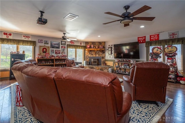 6475 Landsend Ct, Butler Township, OH 45414 - living room with ceiling fan, a stone fireplace, visible vents, and plenty of natural light