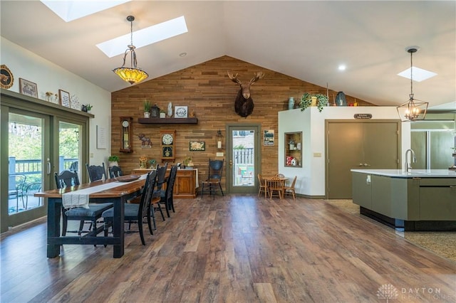 6475 Landsend Ct, Butler Township, OH 45414 - dining area with wooden walls, wood finished floors, a skylight, and high vaulted ceiling