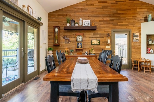6475 Landsend Ct, Butler Township, OH 45414 - dining area featuring high vaulted ceiling, wood walls, and wood finished floors