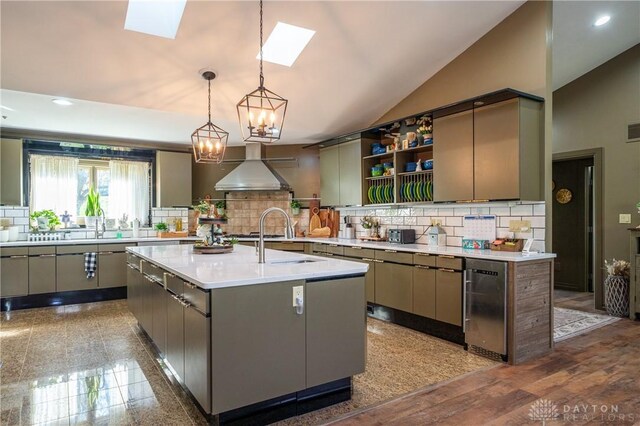 6475 Landsend Ct, Butler Township, OH 45414 - kitchen with a sink, backsplash, and wall chimney range hood