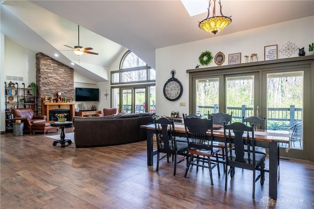 6475 Landsend Ct, Butler Township, OH 45414 - dining area featuring high vaulted ceiling, a stone fireplace, dark wood-style floors, and ceiling fan