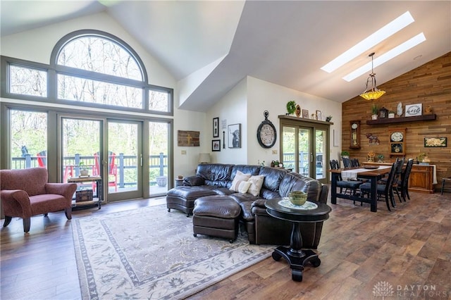 6475 Landsend Ct, Butler Township, OH 45414 - living room featuring plenty of natural light, a skylight, high vaulted ceiling, and wood walls
