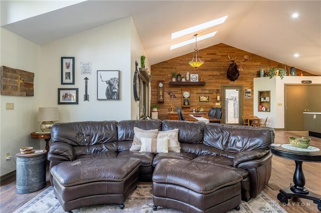 6475 Landsend Ct, Butler Township, OH 45414 - living room featuring wooden walls, wood finished floors, and vaulted ceiling with skylight