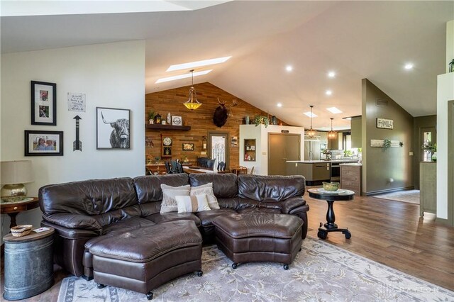 6475 Landsend Ct, Butler Township, OH 45414 - living room featuring wood walls, wood finished floors, and lofted ceiling with skylight